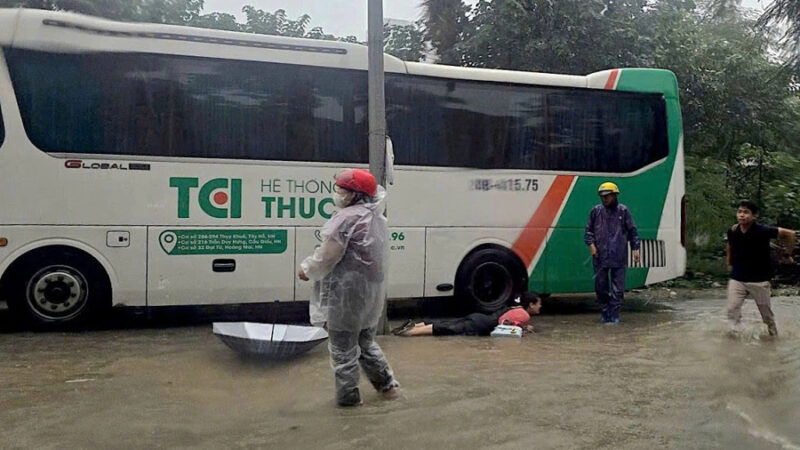 Hanoi residents suffer electric shocks while wading through flooded streets